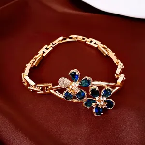 Elegant 18k gold plated bracelet featuring sapphire blue floral cubic zirconia charms