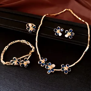 Detailed view of 18k gold plated flower jewelry set with sparkling blue zircons.