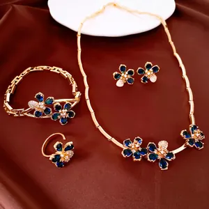 Detail view of 18k gold plated jewelry set featuring elegant blue zircon floral designs