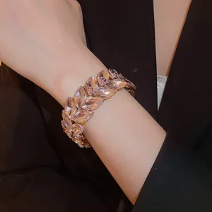 Close-up of an elegant double-layered wheat ear crystal bracelet worn on a wrist for evening