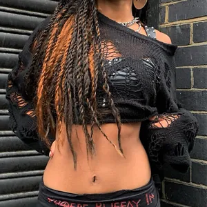 Detailed view of black distressed hollow-out knit sweater featuring a sexy punk aesthetic