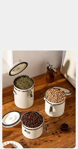 Detail shot of three airtight stainless steel canisters for coffee beans and grains.