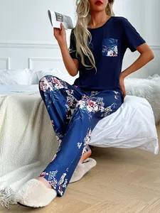 Stylish women's navy blue pajama set featuring floral print pants and a pocket detail