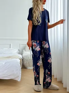 Detailed view of women's two-piece floral pajama set featuring a navy T-shirt and long pants