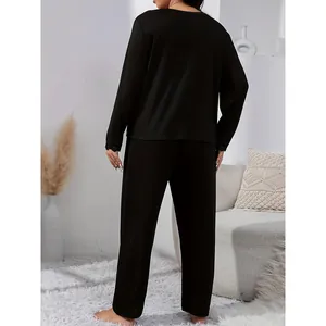 Back view of black lace trim loungewear set with long-sleeved top and straight pants.