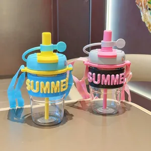 Detailed view of two trendy 'SUMMER' straw water cups in blue and pink with straps.