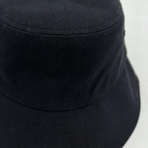 Detailed macro view showing the high-quality stitching and fabric of a black cotton bucket hat