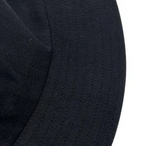 Close-up macro detail of the stitching on a black high-quality cotton bucket hat brim