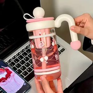 Minimalist pink and white glass water bottle with filter and handle for office