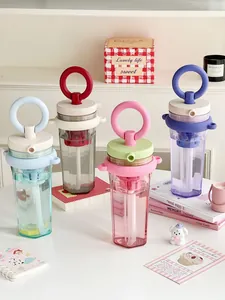 Detailed view of colorful portable water bottles with ring handles and tea filters.