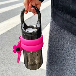 Close-up of a stylish portable water bottle featuring a handle and silicone sleeve