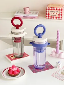Detail shot of aesthetic portable water cups with circular handle and tea filter