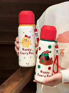 Close-up view of two cute Christmas themed stainless steel thermos bottles with characters
