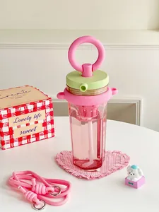 Close-up of pink portable straw water bottle with built-in tea filter
