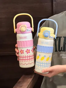 Detailed view of two 316 stainless steel vacuum insulated water bottles with handles