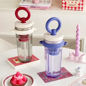 Modern portable water bottle with ring handle, straw, and tea filter for daily use