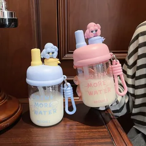 Detailed view of creative double-drinking glass water bottles with cute 3D cartoon figurines