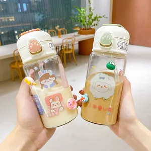 Close-up of two cute portable cartoon glass water bottles with straws and pop-up lids