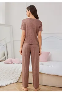 Back view of women's comfortable heathered loungewear pajamas set in cozy bedroom setting