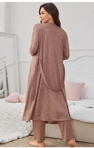 Back view of a chic three-piece French loungewear set in a cozy bedroom setting