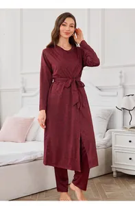 Elegant burgundy three-piece loungewear set including a robe and pants in bedroom