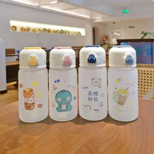 Close-up of four cartoon frosted glass cups with flip lids and cute animal patterns