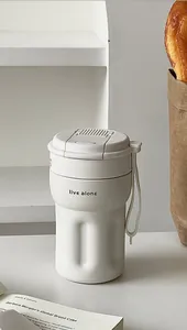 Minimalist insulated portable coffee cup with handheld strap and 'live alone' print detail