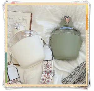 Nordic style plastic water bottle with straw and colorful carrying strap in soft green