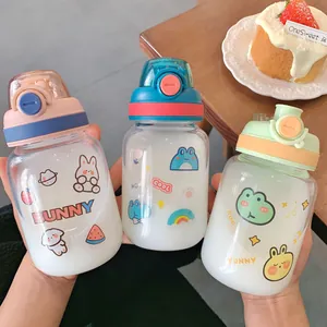 Detailed view of three cute cartoon glass water bottles with flip-top lids in pastel colors