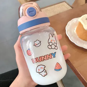 Close-up of cute cartoon bunny water bottle with pink bounce lid on wooden table