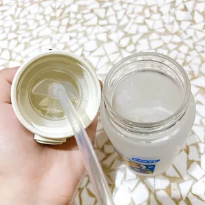 Close-up detail of the straw and open lid of a cartoon frosted glass water bottle