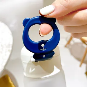 Macro view of a cute blue bear-shaped handle on a white flip-top water bottle