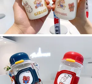 Close-up detail of cute cartoon glass water bottles with protective sleeves and portable straps