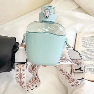 Large mint green plastic water bottle with straw and stylish embroidered carrying strap