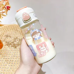 Close-up of cute cartoon glass water bottle with straw and pink paw button