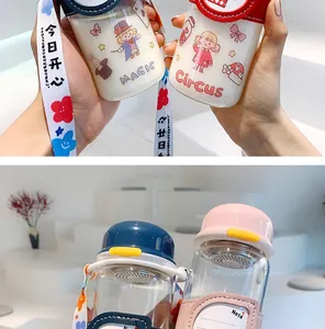 Close-up of cute portable glass water bottles featuring cartoon sleeves and printed straps.