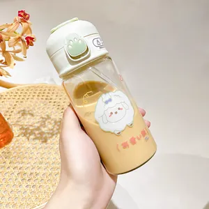 Detail of cute cartoon sheep glass water bottle with straw and cat paw flip lid