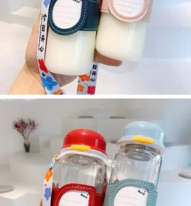 Close-up of portable glass water bottles with colorful insulated sleeves and straps.