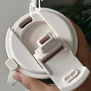 Close-up of minimalist white insulated cup lid with flip cover and straw hole