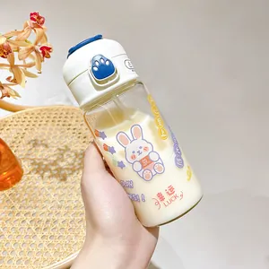 Detailed view of cute cartoon glass water bottle with rabbit pattern and straw