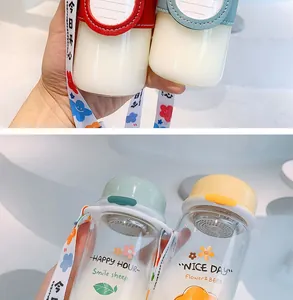 Close-up detail of cute portable glass bottles with floral prints and colorful lids