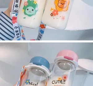 Close-up of cute portable glass water bottles with cartoon designs and tea filters.