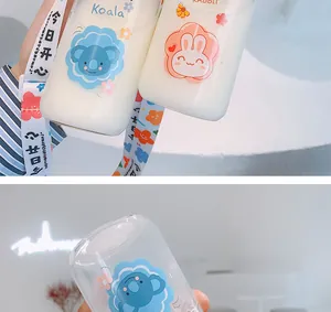 Detail view of cute glass water bottle featuring Koala print and colorful fabric strap