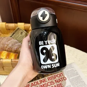 Minimalist black stainless steel vacuum insulated water bottle with straw being held by hand