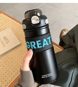 Close-up of black stainless steel insulation cup with blue GREAT grip detail
