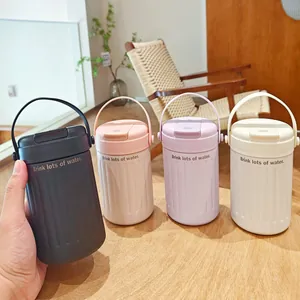 Set of four minimalist pastel stainless steel water bottles in a cozy indoor setting