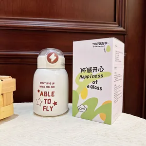 Detailed shot of a white insulated water bottle next to its matching decorative gift box