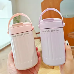 Macro view of portable pastel pink and purple insulated water bottles with carry handles