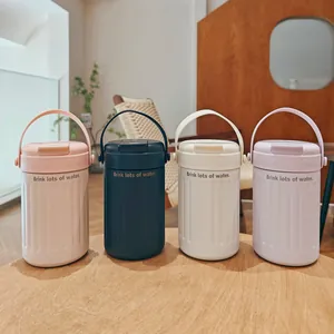 Set of minimalist stainless steel travel mugs in pastel colors on a wooden table