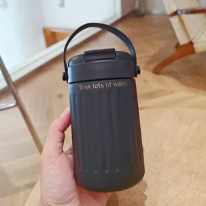 Matte black stainless steel insulated water bottle with carry handle and dual-lid